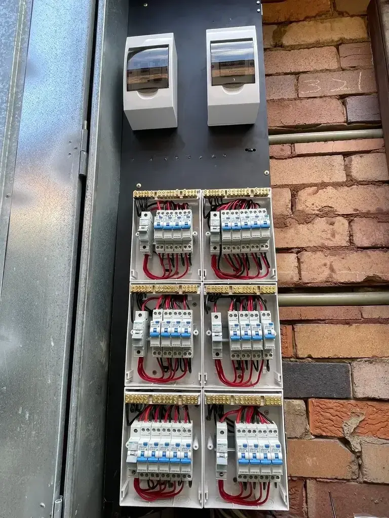 An electrical panel with six circuit breakers connected to wiring.